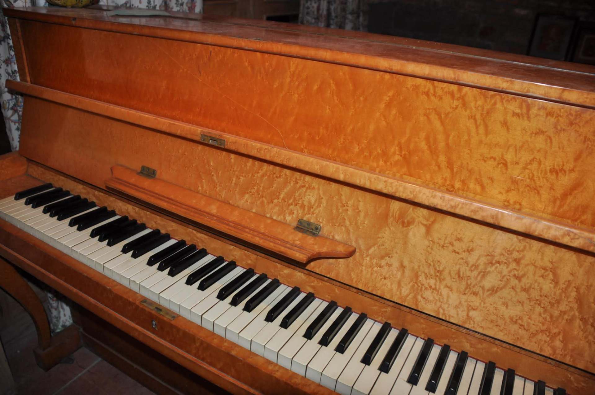 Antique birdseye-maple piano in the lounge